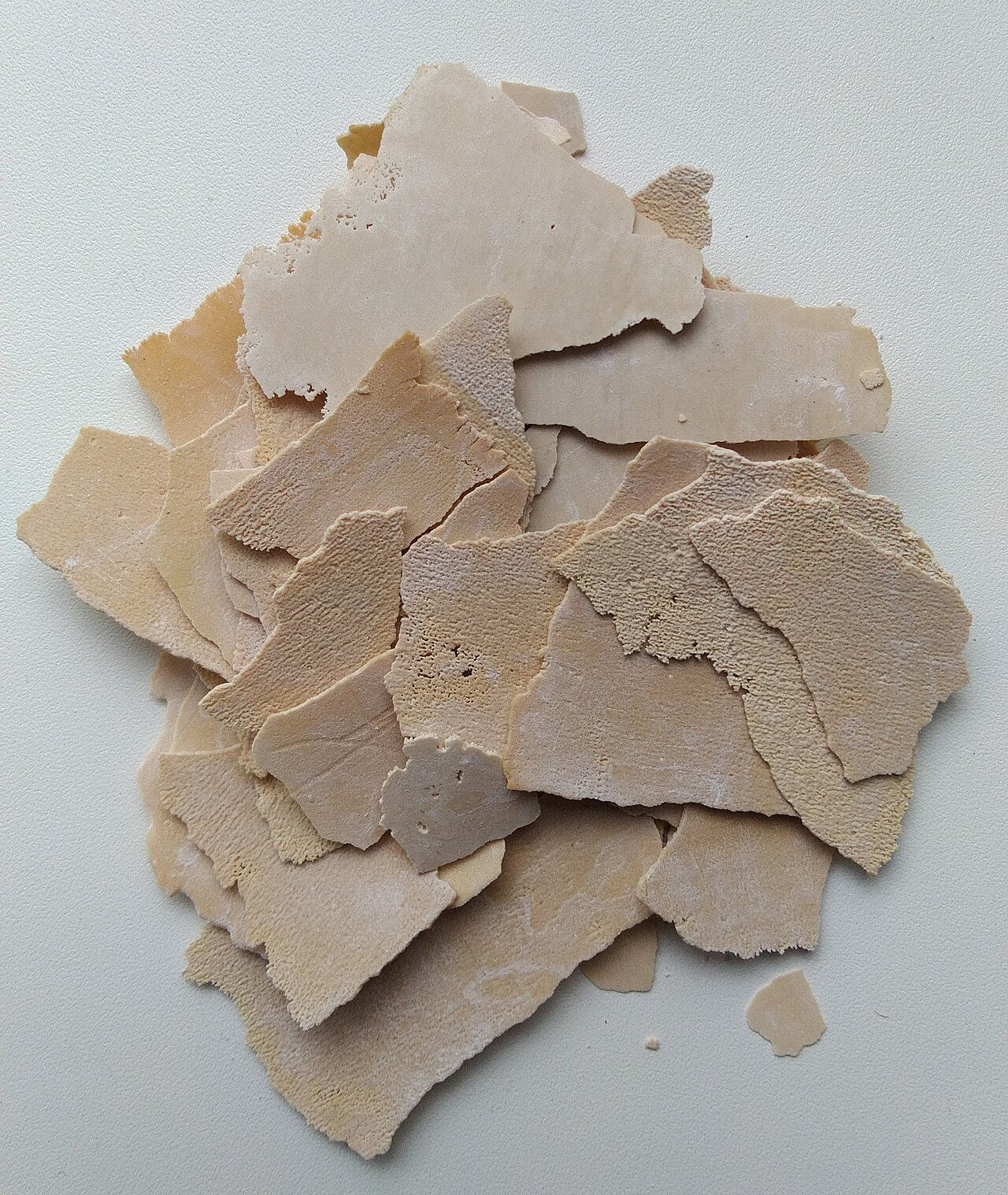 A pile of thick limescale flakes removed from a kettle. Alexander Davronov, CC BY-SA 4.0, via Wikimedia Commons